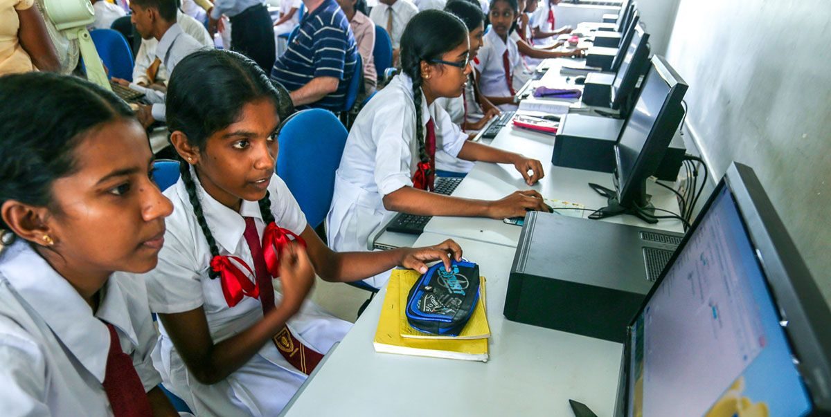 Sri Lankan schoolchildren working at computers in a school lab